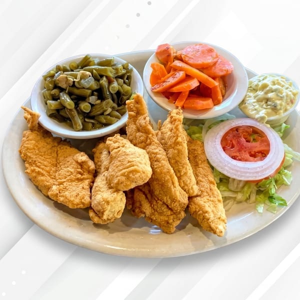Fried chicken tenders with sides of green beans, carrots, coleslaw, and a small salad.